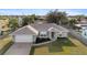 Charming single-story home with well-maintained landscaping, a large driveway, and an attached two-car garage at 2443 Lake View Blvd, Port Charlotte, FL 33948