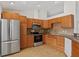 Well-equipped kitchen with stainless steel appliances and plentiful wood cabinetry for storage convenience at 2443 Lake View Blvd, Port Charlotte, FL 33948
