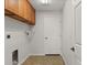 Laundry room with overhead cabinets, a shelf for supplies, a utility sink connection, and a tiled floor at 2443 Lake View Blvd, Port Charlotte, FL 33948