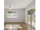 Bright living room with neutral walls, ceiling fan, and sliding glass doors to the outside at 2443 Lake View Blvd, Port Charlotte, FL 33948