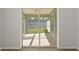Enclosed patio with tile flooring and white trim, leading to the backyard through a sliding door at 2443 Lake View Blvd, Port Charlotte, FL 33948