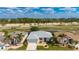 Aerial view of the property showcases its prime location with a pond and lush greenery at 24576 Buckingham Way, Punta Gorda, FL 33980