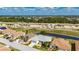 Overhead view of a home next to a golf course and highway, with palm trees for privacy at 24576 Buckingham Way, Punta Gorda, FL 33980
