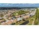 This aerial view showcases the property's location near a lush green golf course and community at 24576 Buckingham Way, Punta Gorda, FL 33980
