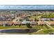 Aerial view of a lovely home featuring a screened-in lanai, situated on a pond with golf course views at 24576 Buckingham Way, Punta Gorda, FL 33980