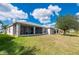 Well-maintained backyard features a screened lanai and views of the surrounding greenery at 24576 Buckingham Way, Punta Gorda, FL 33980