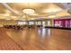 Community ballroom featuring a stage, hardwood dance floor, and tables with chairs at 24576 Buckingham Way, Punta Gorda, FL 33980