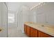 Bathroom featuring a double vanity, large mirror, and tile flooring, offering ample space at 24576 Buckingham Way, Punta Gorda, FL 33980