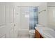 Bathroom featuring a shower-tub combo with a shower curtain, toilet, and a vanity with sink at 24576 Buckingham Way, Punta Gorda, FL 33980