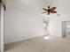 Large bedroom with neutral carpet, plenty of natural light, and a ceiling fan at 24576 Buckingham Way, Punta Gorda, FL 33980