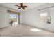 Spacious bedroom features a slider to screened porch and ample natural light at 24576 Buckingham Way, Punta Gorda, FL 33980