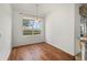 Bright dining area with hardwood floors and a large window for natural light at 24576 Buckingham Way, Punta Gorda, FL 33980