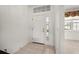 Foyer area with tiled flooring, natural light, and a view into the living area at 24576 Buckingham Way, Punta Gorda, FL 33980