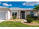 Charming front entrance with manicured landscaping and decorative accents at 24576 Buckingham Way, Punta Gorda, FL 33980