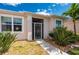 Close up of Front door with a security screen and well-maintained yard at 24576 Buckingham Way, Punta Gorda, FL 33980