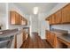 Long kitchen layout with wood cabinets and sleek appliances maximizes space and functionality at 24576 Buckingham Way, Punta Gorda, FL 33980