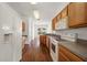 Functional kitchen boasts wood cabinets, white appliances, and durable countertops at 24576 Buckingham Way, Punta Gorda, FL 33980