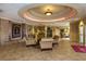 Community center lobby featuring comfortable seating, decorative plants, and elegant lighting at 24576 Buckingham Way, Punta Gorda, FL 33980