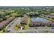 The aerial shows the complex, ample parking, and attractive landscaping around the buildings and common areas at 25100 Sandhill Blvd # J-201, Punta Gorda, FL 33983