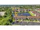 Beautiful aerial view of condo community with lush landscaping and a serene pond at 25100 Sandhill Blvd # J-201, Punta Gorda, FL 33983