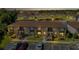 Aerial view of condo buildings, parking, and a tranquil pond in a community setting at 25100 Sandhill Blvd # J-201, Punta Gorda, FL 33983