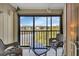 Enclosed balcony overlooking a serene lake, with comfortable seating for relaxing at 25100 Sandhill Blvd # J-201, Punta Gorda, FL 33983