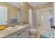 This bathroom features a shower/tub combination, white cabinets, and a toilet at 25100 Sandhill Blvd # J-201, Punta Gorda, FL 33983
