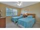 Charming bedroom featuring two twin beds, a ceiling fan, and a bright window at 25100 Sandhill Blvd # J-201, Punta Gorda, FL 33983