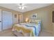 This bright bedroom features a queen bed and a window with a view of the neighborhood at 25100 Sandhill Blvd # J-201, Punta Gorda, FL 33983