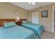 Charming bedroom featuring two twin beds, a ceiling fan, and a bright window at 25100 Sandhill Blvd # J-201, Punta Gorda, FL 33983