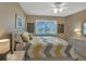 This bright bedroom features a queen bed and a window with a view of the neighborhood at 25100 Sandhill Blvd # J-201, Punta Gorda, FL 33983