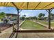 View of the community's bocce ball court, with picnic shelter, landscaping, and community tables at 25100 Sandhill Blvd # J-201, Punta Gorda, FL 33983