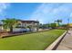 View of the community's bocce ball court, with picnic shelter, landscaping, and community tables at 25100 Sandhill Blvd # J-201, Punta Gorda, FL 33983