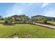 Lush common area with a picnic shelter and tables nestled among mature trees at 25100 Sandhill Blvd # J-201, Punta Gorda, FL 33983