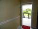 Bright condo entryway showcasing neutral paint and a glimpse of the exterior at 25100 Sandhill Blvd # J-201, Punta Gorda, FL 33983