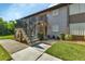 Exterior view of a two-story apartment building with stairs leading to the upper units at 25100 Sandhill Blvd # J-201, Punta Gorda, FL 33983