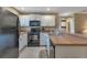 Modern condo kitchen with white cabinetry and stainless steel appliances at 25100 Sandhill Blvd # J-201, Punta Gorda, FL 33983