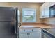 This bright kitchen features stainless steel appliances and a large window overlooking the yard at 25100 Sandhill Blvd # J-201, Punta Gorda, FL 33983