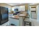 This kitchen features white cabinets, stainless steel appliances, and a breakfast bar at 25100 Sandhill Blvd # J-201, Punta Gorda, FL 33983