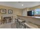 Kitchenette featuring a counter with bar seating, a table for two, and essential appliances at 25100 Sandhill Blvd # J-201, Punta Gorda, FL 33983