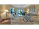 Inviting living room with a large television, comfortable seating, and a view to the balcony at 25100 Sandhill Blvd # J-201, Punta Gorda, FL 33983