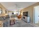 Cozy condo living room with neutral decor, ceiling fan, and dining area at 25100 Sandhill Blvd # J-201, Punta Gorda, FL 33983