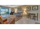Comfortable living room with neutral tones, tile flooring, and access to the lanai at 25100 Sandhill Blvd # J-201, Punta Gorda, FL 33983