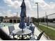 The community pool features comfortable seating areas with tables and umbrellas for shade at 25100 Sandhill Blvd # J-201, Punta Gorda, FL 33983