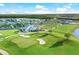Aerial view of the golf course, clubhouse, surrounding neighborhood and lakes at 25186 Keygrass Ct, Punta Gorda, FL 33955