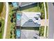 Aerial view of the home showcasing the screened-in pool, landscaped yard, and elegant roof design at 25186 Keygrass Ct, Punta Gorda, FL 33955