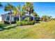 Expansive backyard with well-manicured lawn and tropical foliage, creating a private oasis for relaxation and recreation at 25186 Keygrass Ct, Punta Gorda, FL 33955