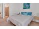 Bright bedroom with white walls, blue accents and a tiled bathroom with shower at 25186 Keygrass Ct, Punta Gorda, FL 33955