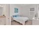 Bright bedroom with white walls, blue accents, and neutral carpet at 25186 Keygrass Ct, Punta Gorda, FL 33955