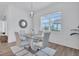 Dining area with a modern glass table and a view of palm trees outside at 25186 Keygrass Ct, Punta Gorda, FL 33955